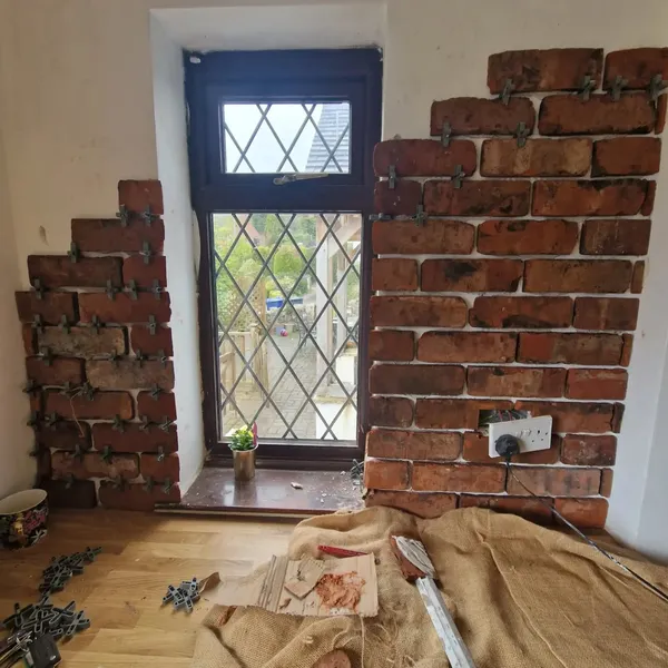 Reclaimed brick slip feature wall installation around a leaded window