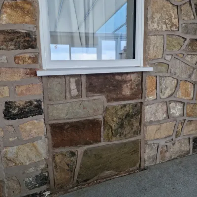 Natural stone exterior wall with window surround