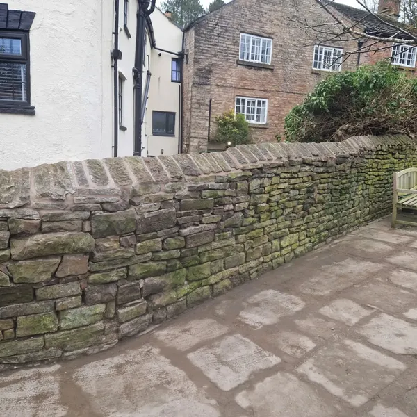 Traditional stone boundary wall with coping stones in a Cheshire village
